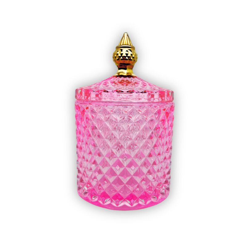 Pojemnik wraz z zakrętką do zalewu świec stojący na stole kolor różowy połysk