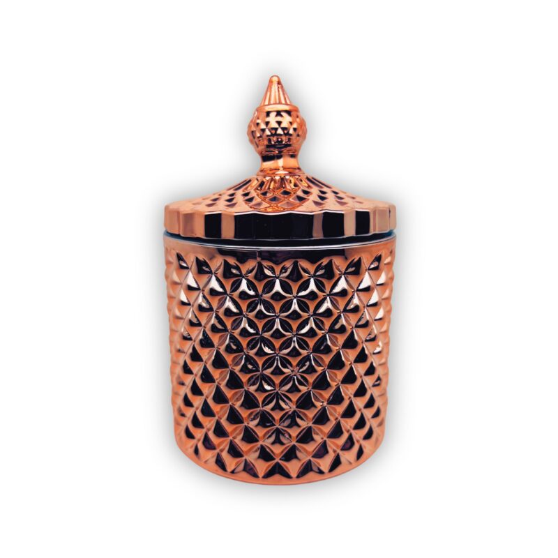 Pojemnik wraz z zakrętką do zalewu świec stojący na stole kolor złoty połysk